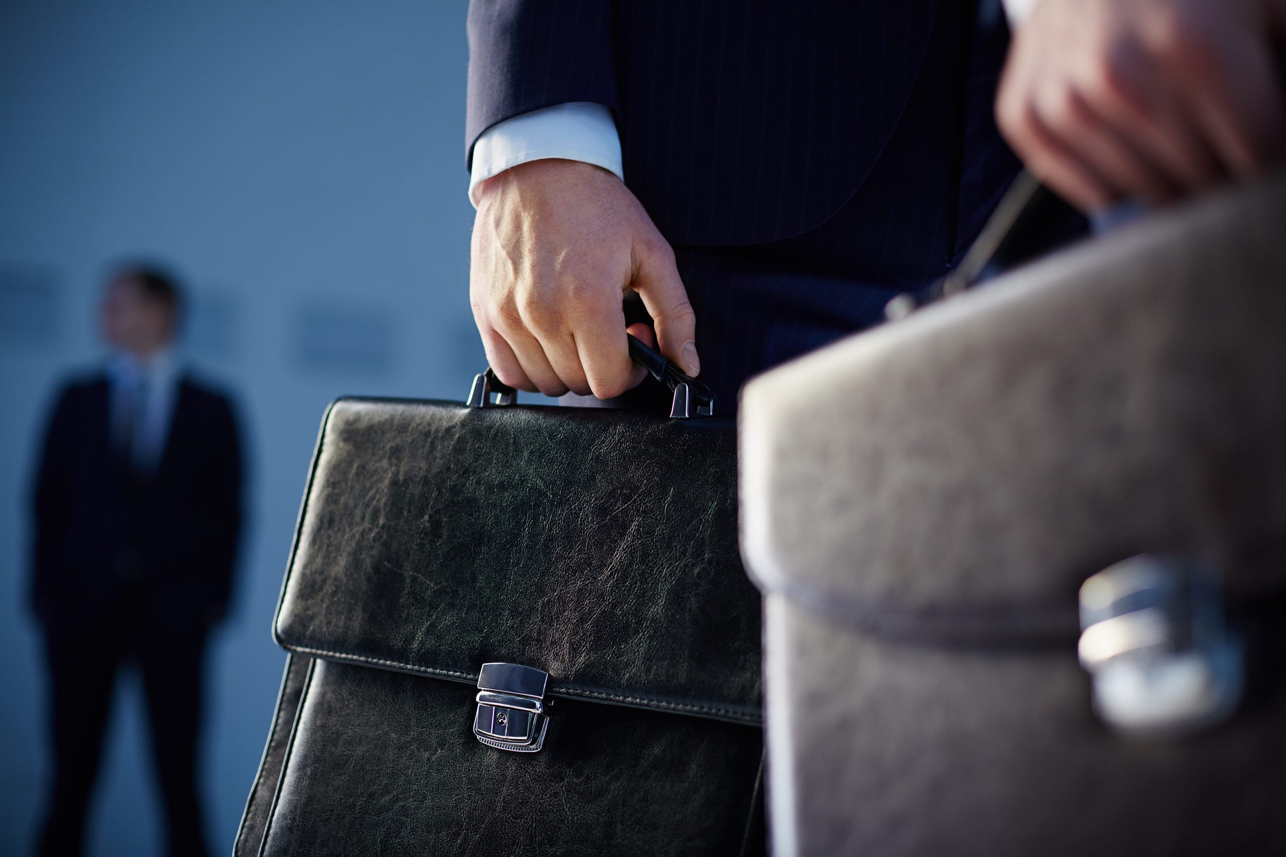 close-up-of-workers-with-briefcases-1-scaled
